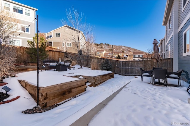 snowy yard with an outdoor fire pit