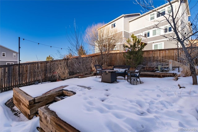 yard layered in snow with a fire pit