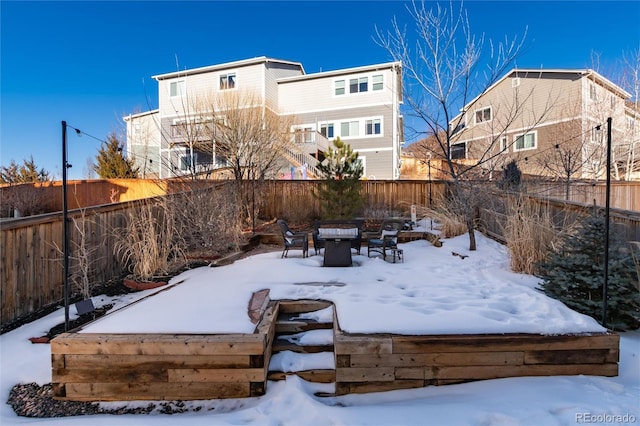 yard layered in snow with a fire pit