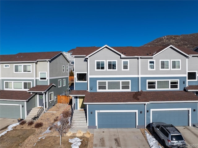 townhome / multi-family property featuring a garage and a mountain view