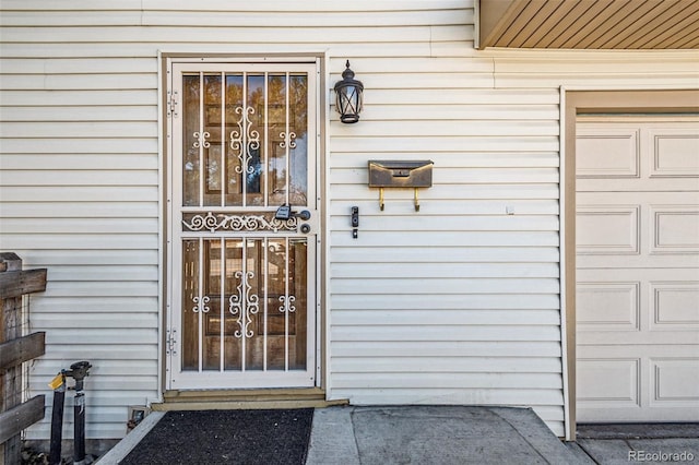 doorway to property with a garage