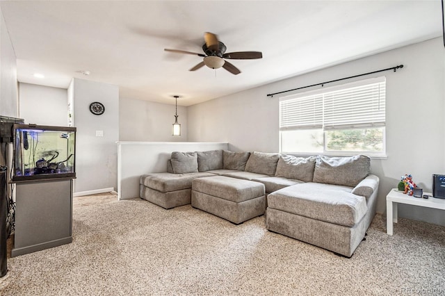 living room with baseboards and ceiling fan