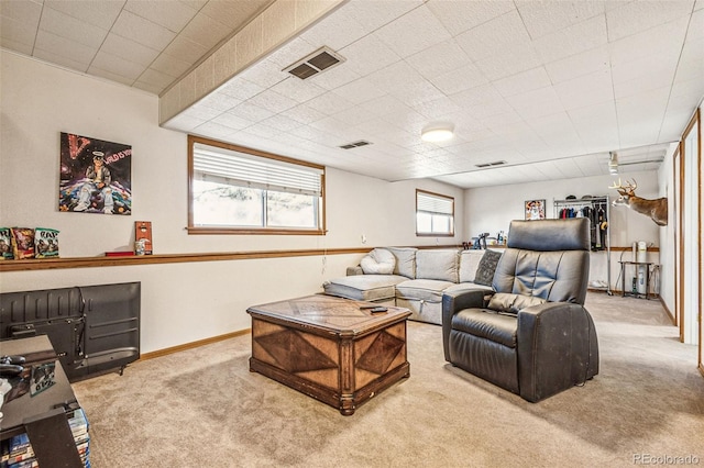 carpeted living area with baseboards and visible vents