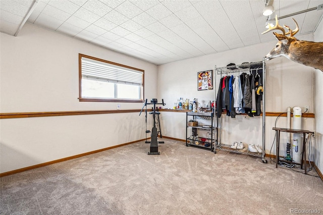 workout room with baseboards and carpet floors