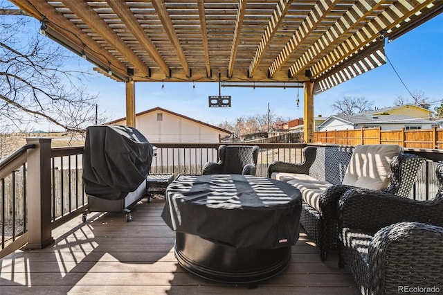 wooden deck featuring fence, a pergola, and grilling area