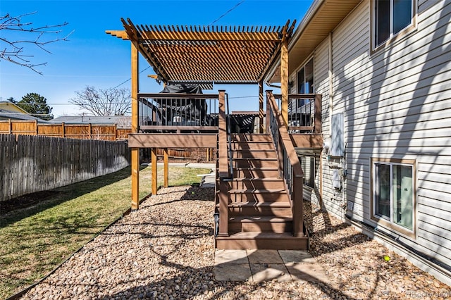 view of yard featuring a wooden deck, stairway, a pergola, and fence