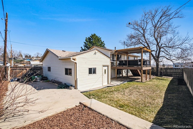 rear view of house with a deck, a patio, a fenced backyard, a yard, and stairway