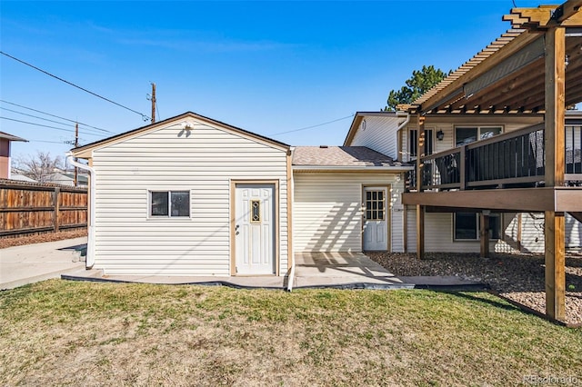 back of property featuring a yard, a patio, and fence