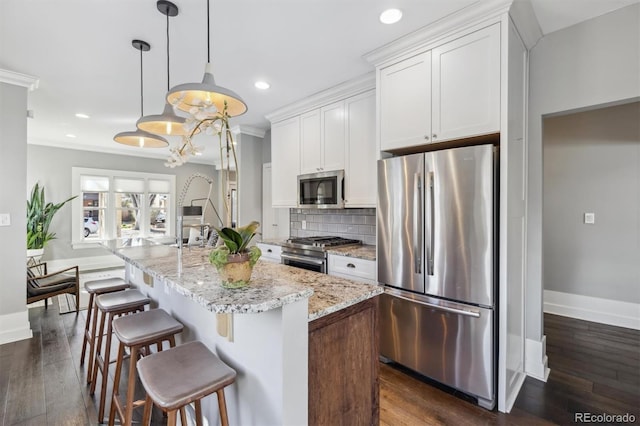 1626 Albion St, Denver, CO 80220 - kitchen with stainless steel appliances, baseboards, recessed lighting, white cabinetry, and decorative backsplash
