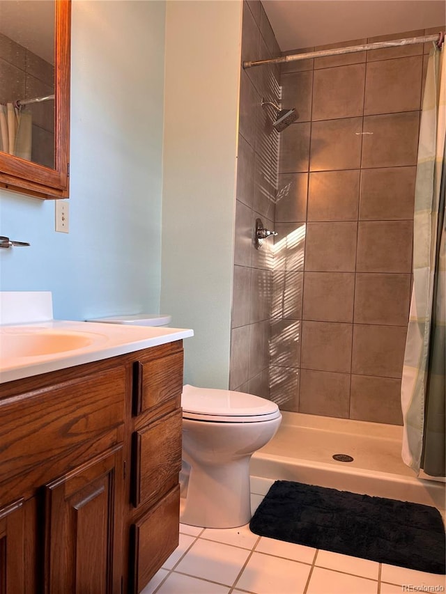 bathroom with vanity, a stall shower, tile patterned flooring, and toilet