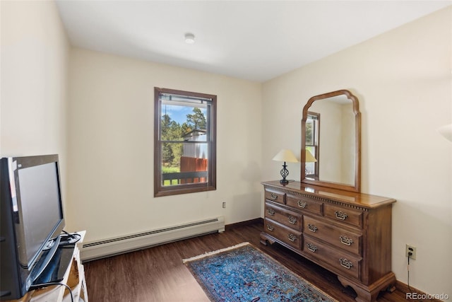 interior space with a baseboard radiator, baseboards, and dark wood-type flooring