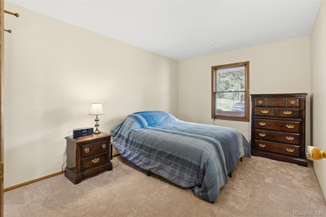 bedroom featuring baseboards and light colored carpet