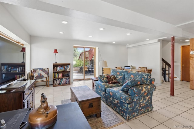 living area featuring light tile patterned floors, a baseboard radiator, stairway, and recessed lighting