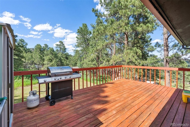 wooden terrace featuring area for grilling