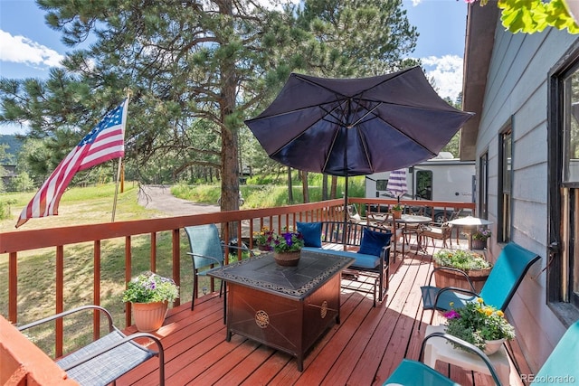 wooden deck featuring a yard and outdoor dining space