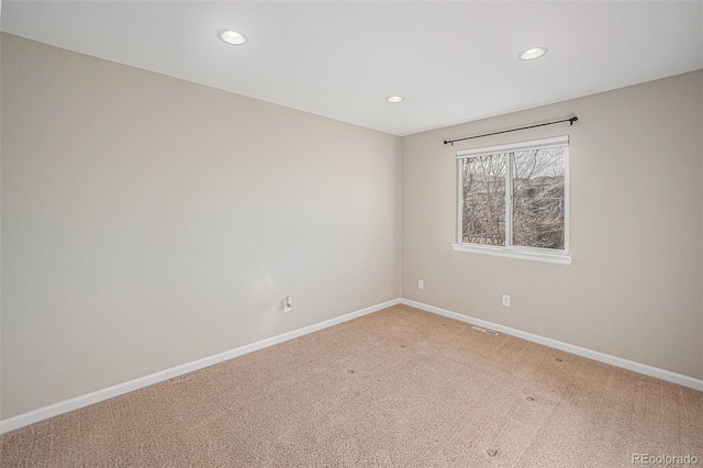 unfurnished room with recessed lighting, visible vents, baseboards, and light colored carpet