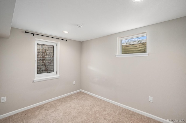 carpeted empty room with baseboards