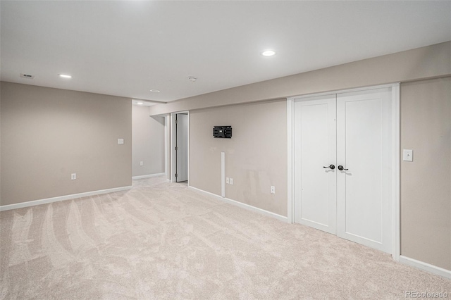 finished below grade area featuring carpet floors, visible vents, baseboards, and recessed lighting