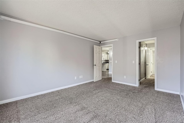 unfurnished bedroom featuring dark carpet and a textured ceiling