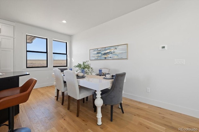 dining space with light wood-type flooring