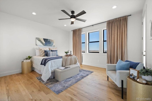 bedroom with ceiling fan and light hardwood / wood-style flooring