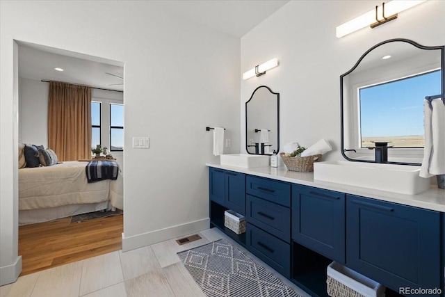 bathroom with hardwood / wood-style flooring, vanity, and a wealth of natural light