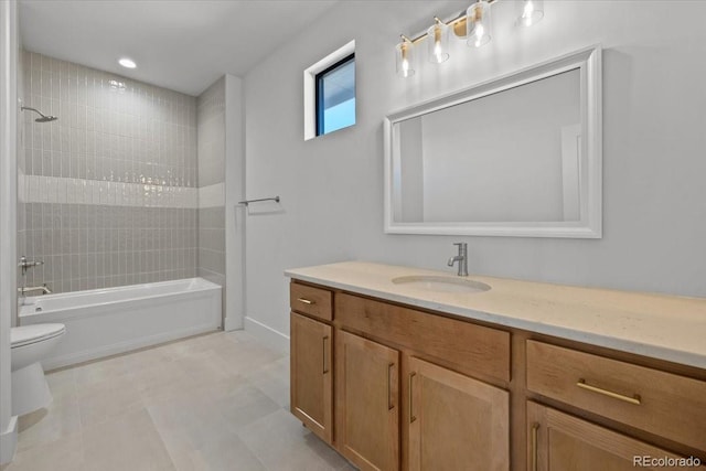 full bathroom featuring tiled shower / bath, vanity, and toilet