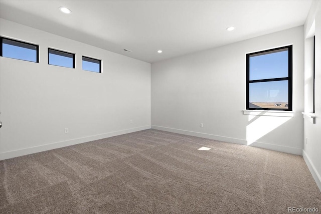 carpeted spare room with plenty of natural light