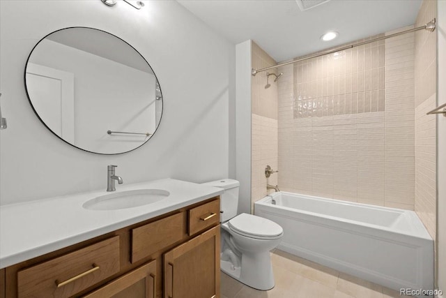 full bathroom featuring tiled shower / bath combo, vanity, tile patterned flooring, and toilet