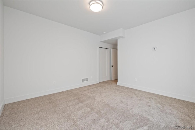 unfurnished room with light colored carpet