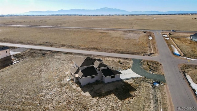 birds eye view of property featuring a mountain view