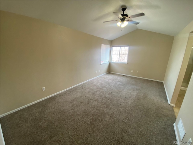 unfurnished bedroom featuring visible vents, baseboards, lofted ceiling, carpet floors, and a ceiling fan