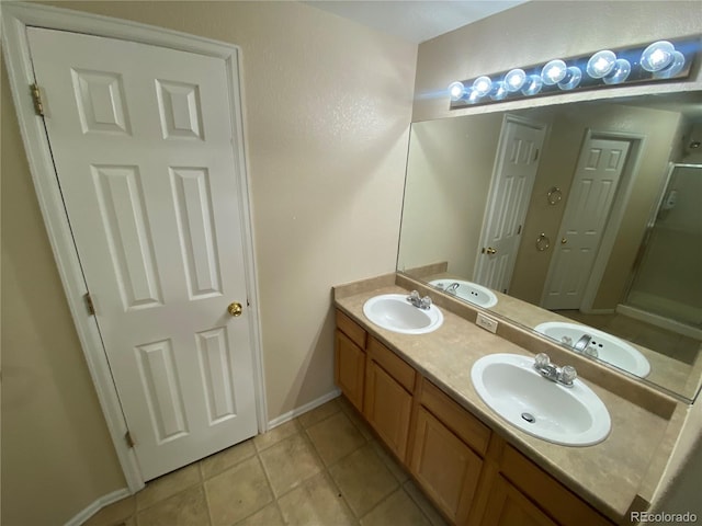 full bathroom featuring a sink, a shower stall, and double vanity