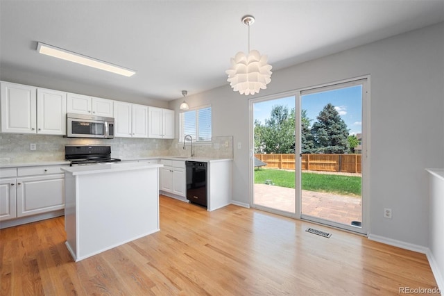 kitchen featuring light wood-type flooring, white cabinetry, stove, and dishwasher