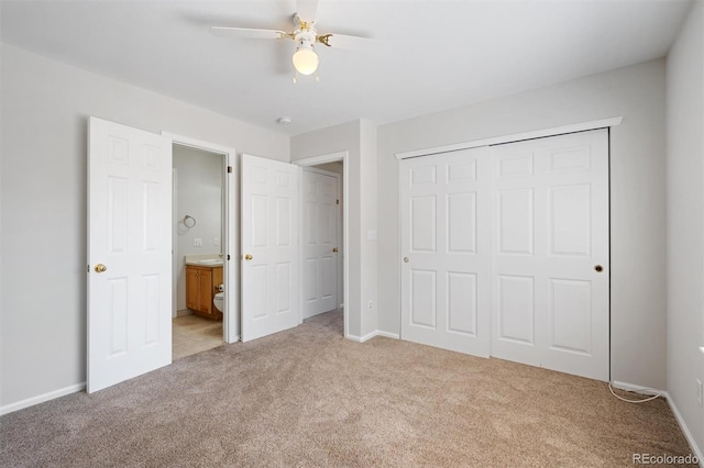 unfurnished bedroom with ceiling fan, light colored carpet, and a closet