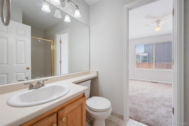 bathroom with ceiling fan, toilet, vanity, and tile patterned floors