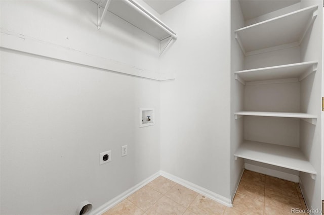 clothes washing area featuring hookup for an electric dryer, washer hookup, and light tile patterned flooring