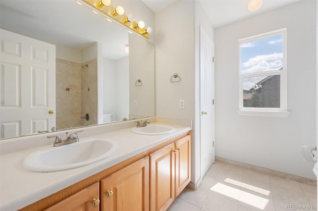 bathroom with tile patterned flooring, toilet, and dual vanity