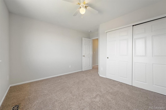 unfurnished bedroom featuring a closet, ceiling fan, and light carpet