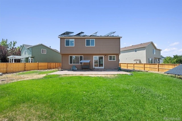 rear view of house featuring a lawn and a patio area