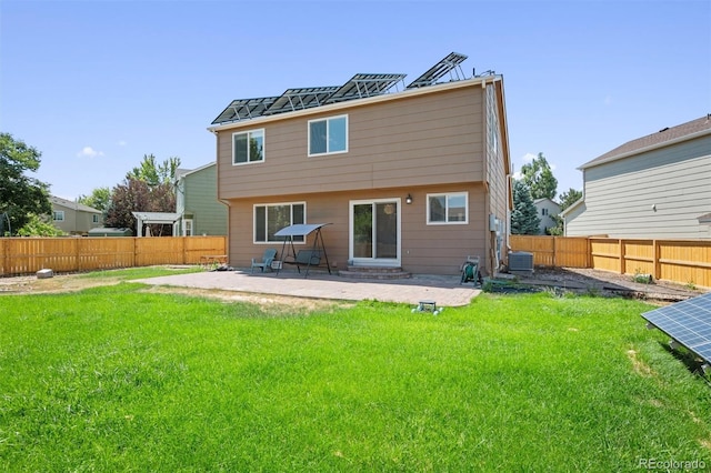 rear view of property featuring a patio area and a lawn