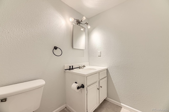 4653 S Lowell Blvd Unit E, Denver, CO 80236 - half bathroom with toilet, vanity, tile patterned floors, and baseboards