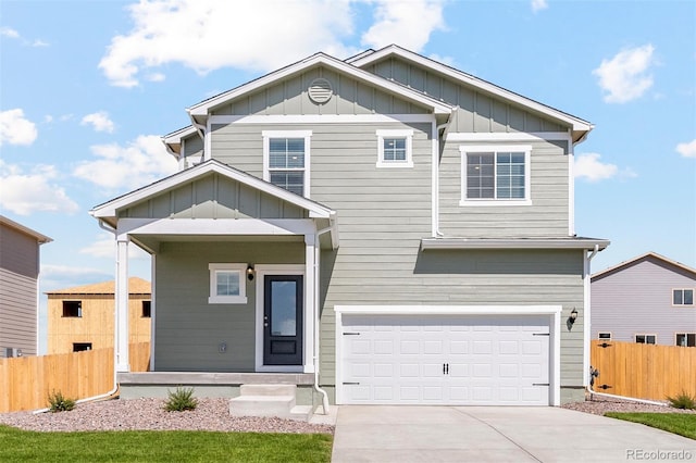 craftsman-style house featuring fence, a garage, concrete driveway, and board and batten siding