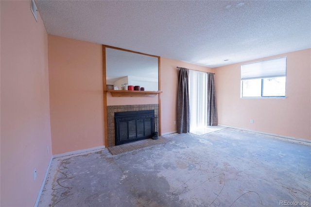 12506 E Cornell Ave Unit 102, Aurora, CO 80014 - unfurnished living room featuring a textured ceiling and a tile fireplace