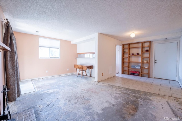 12506 E Cornell Ave Unit 102, Aurora, CO 80014 - unfurnished living room featuring a textured ceiling