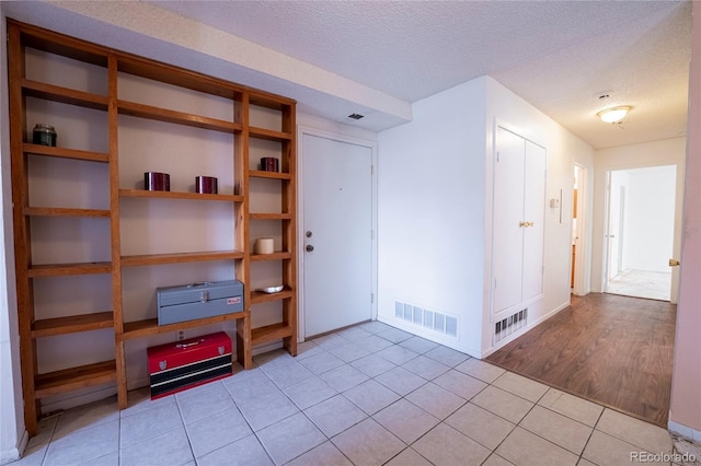 12506 E Cornell Ave Unit 102, Aurora, CO 80014 - empty room featuring light tile patterned floors and a textured ceiling