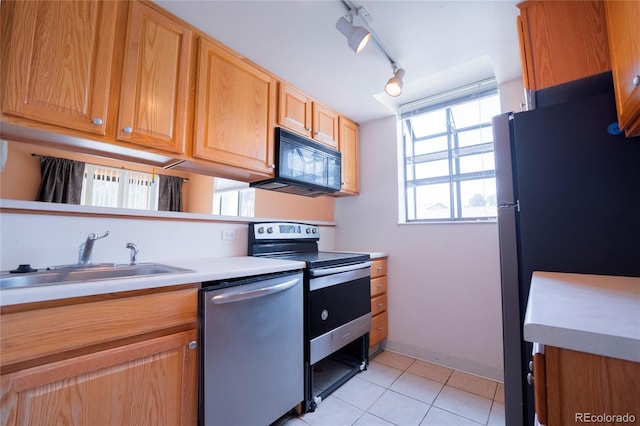 12506 E Cornell Ave Unit 102, Aurora, CO 80014 - kitchen featuring stainless steel appliances, light tile patterned floors, light countertops, and rail lighting