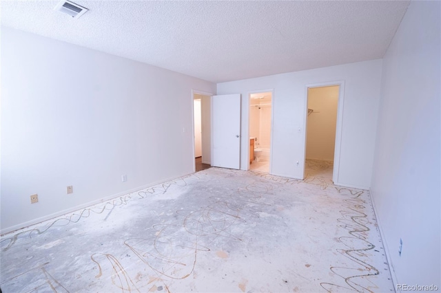 12506 E Cornell Ave Unit 102, Aurora, CO 80014 - unfurnished bedroom with a spacious closet and a textured ceiling