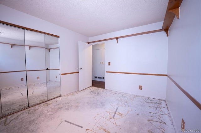 12506 E Cornell Ave Unit 102, Aurora, CO 80014 - unfurnished bedroom with a textured ceiling and a closet