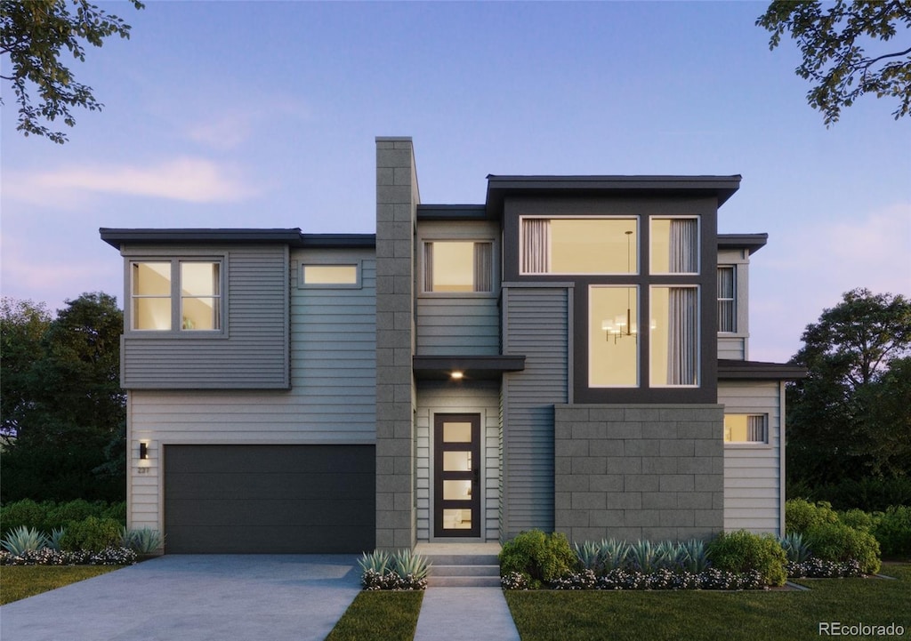 contemporary house featuring an attached garage, concrete driveway, and a chimney